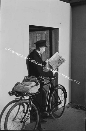 POSTMAN READING NEWSPAPER, IRISH IDEPENDENT